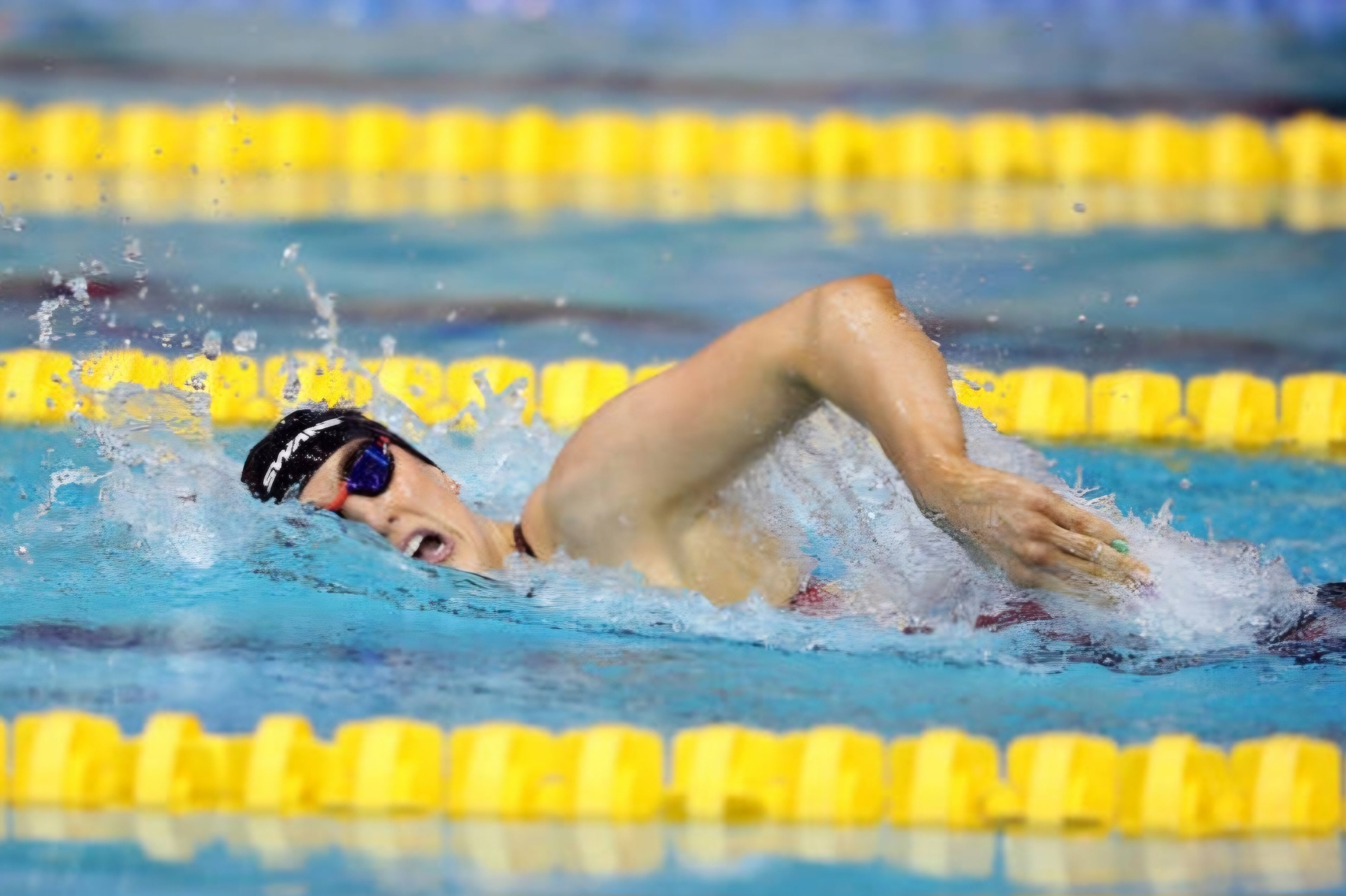 Bethany Firth, Parathlete swimming in a pool with yellow lane dividers